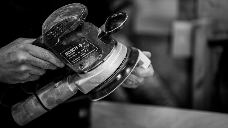 Craftsperson using power tools in workshop representing human skills that AI cannot replicate