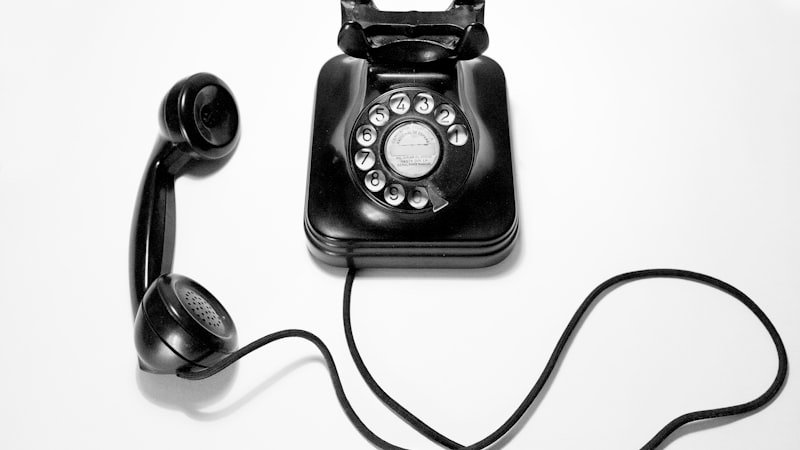 Black rotary dial telephone representing the lost habit of memorizing phone numbers
